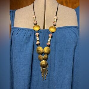 This is a vintage Peruvian Sol currency coin beaded necklace with ceramic beads